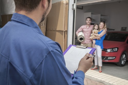 Movers carefully packing household items for relocation in Shooters Hill